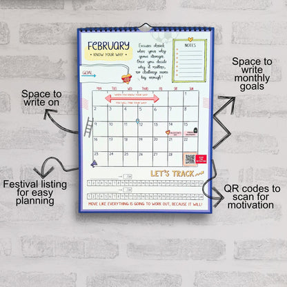 Calendar with motivational text and QR codes on a gray brick wall background