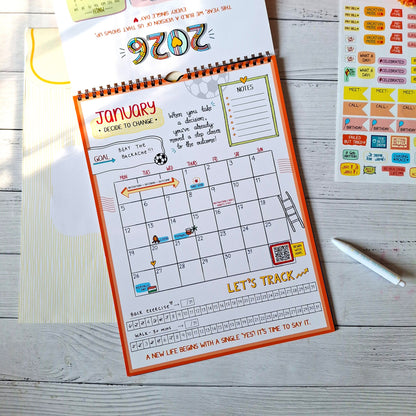 Calendar with January layout on a wooden surface with decorative items