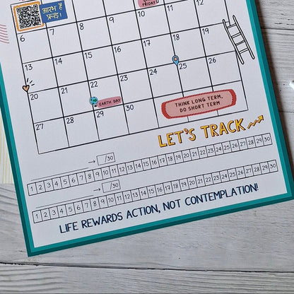 Calendar pages for April and October on a wooden surface with habit tracker